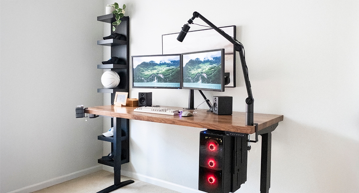 Gamer desk setup featuring various UPLIFT Desk products including the Clamp-On Microphone Arm.