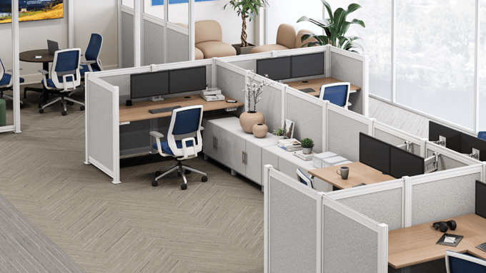 UPLIFT Spaces half-height walls create private workspaces featuring an UPLIFT standing desk, Envoke chair and ergonomic accessories.