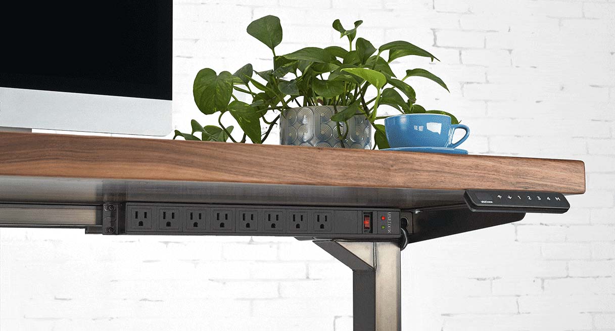 Surge Protector mounted to UPLIFT frame accessory mounting points with front-facing outlets.