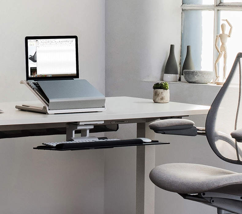 The Humanscale L6 laptop holder in use on top of an UPLIFT Desk.