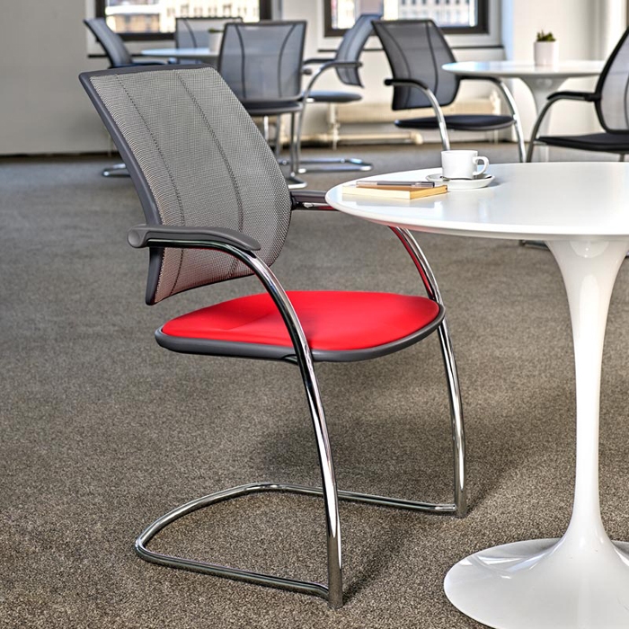 A Humanscale Diffrient Occasional Side Chair beside a table