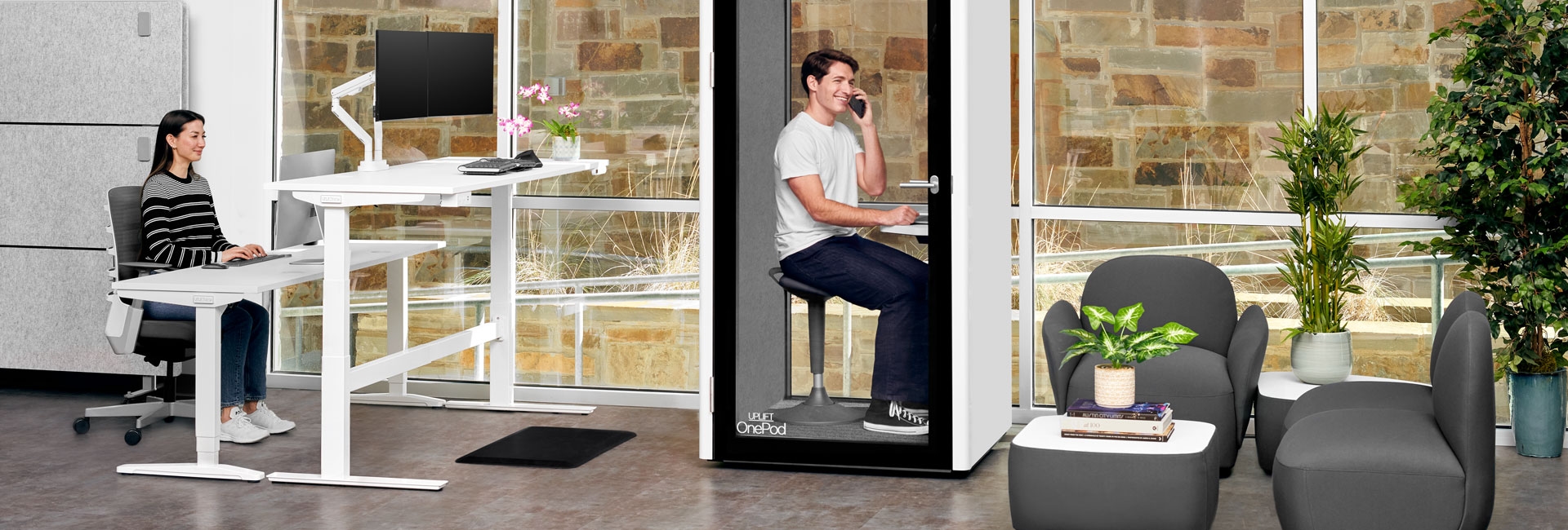 A Dillo Lounge Collection configuration with a OnePod Office Phone Booth and UPLIFT Standing Desks