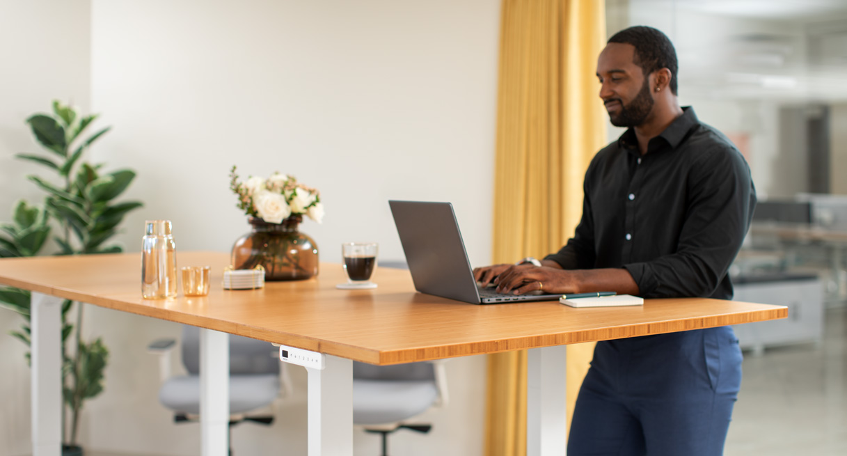 Person standing at an UPLIFT Desk Height Adjustable Conference Table