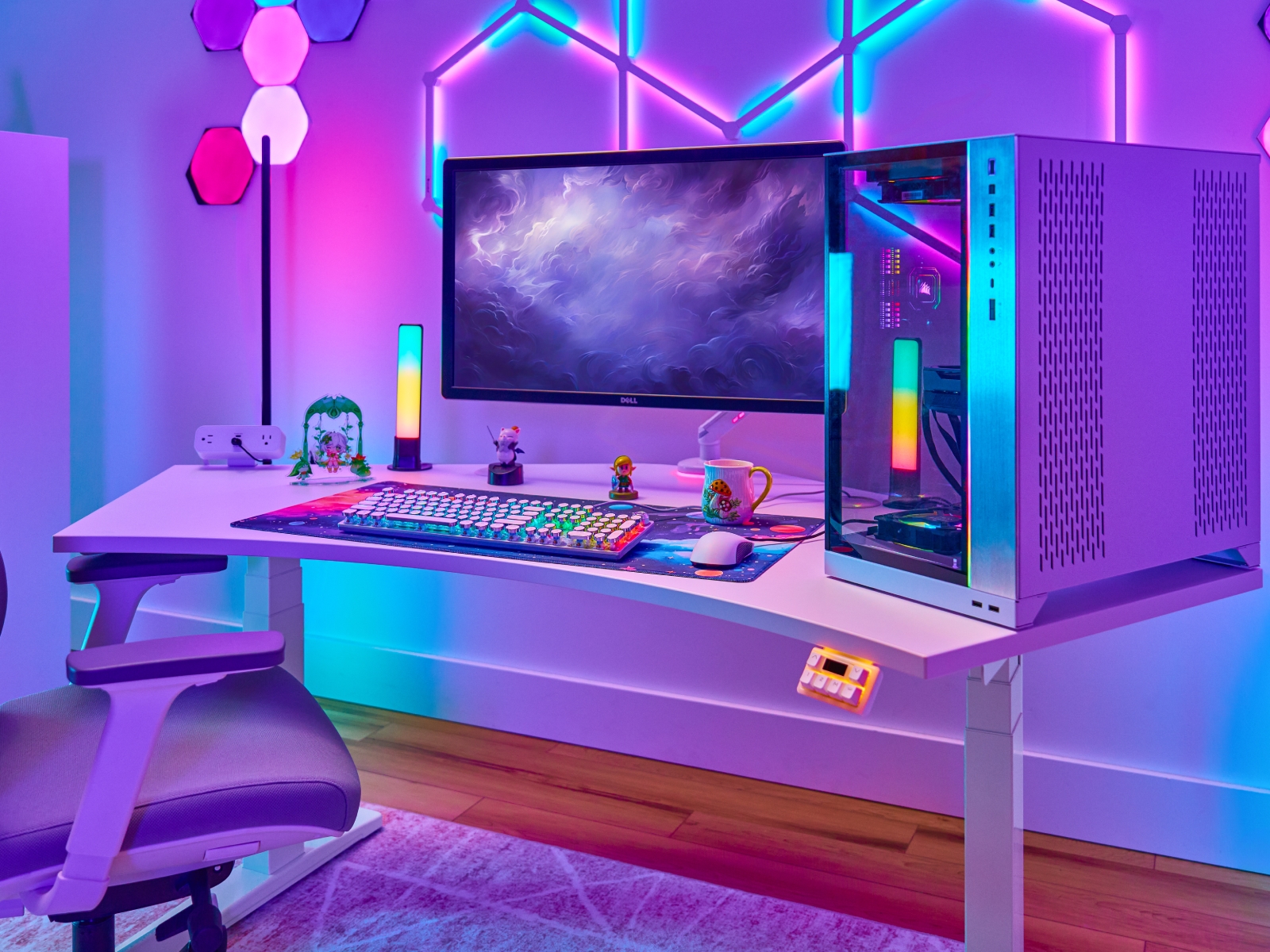 Gamer working at a standing desk by UPLIFT Desk, RGB lighting featured.