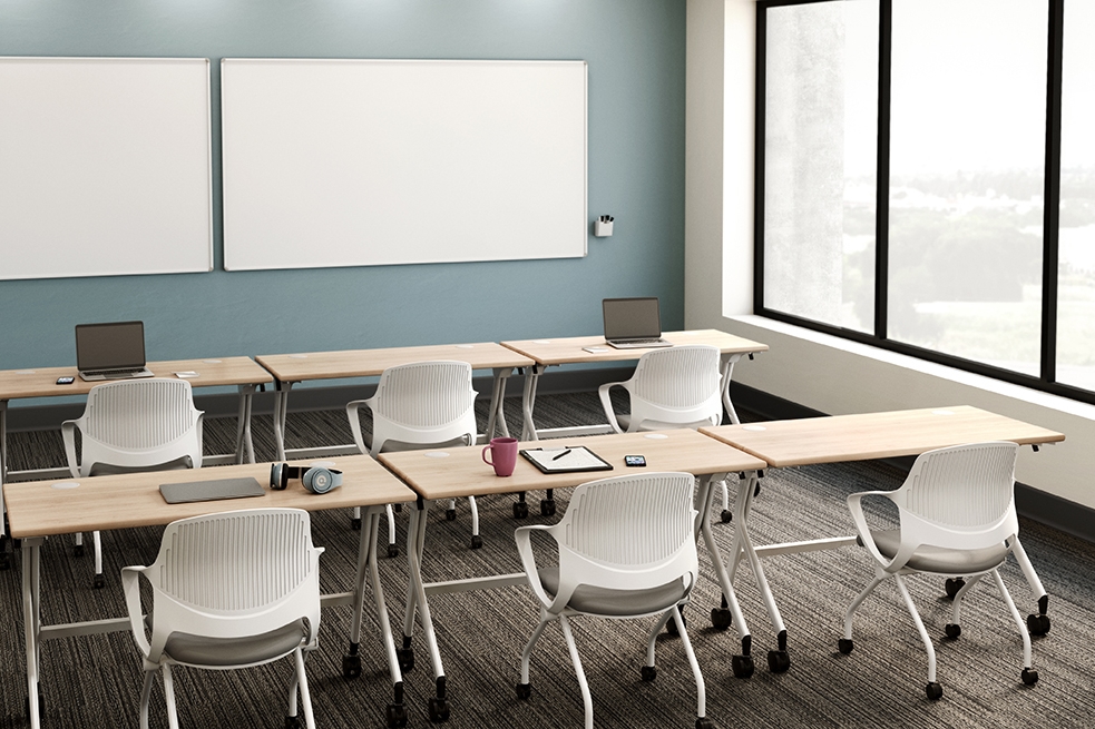 Rollaway nesting chairs and Flip top tables by UPLIFT Desk in a classroom setting.