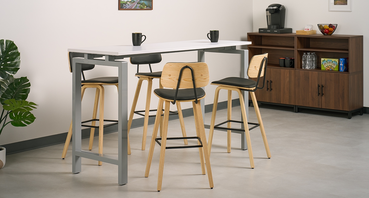 Four Kerbey Barstools by UPLIFT Desk positioned around a bar-height table