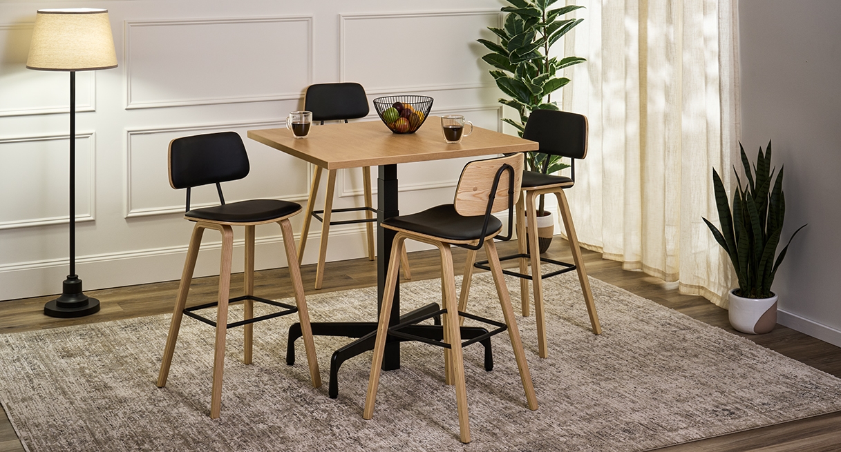 Four Kerbey Barstools by UPLIFT Desk positioned around a bistro table