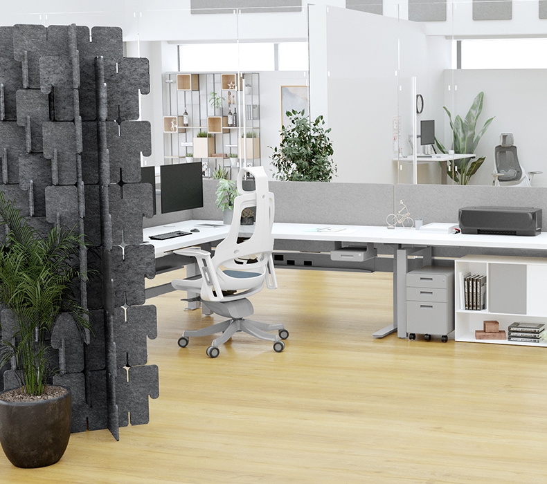 A Bonnell Acoustic Puzzle wall creates a quiet workspace for a C-shape desk configuration