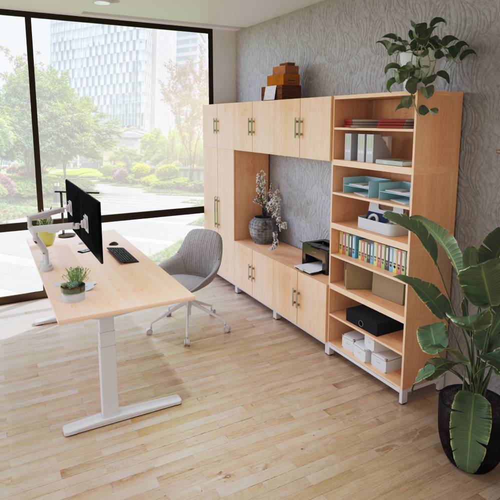 2-leg v3 white frame standing desk with maple desktop alongside maple mopac cabinets and wardrobe