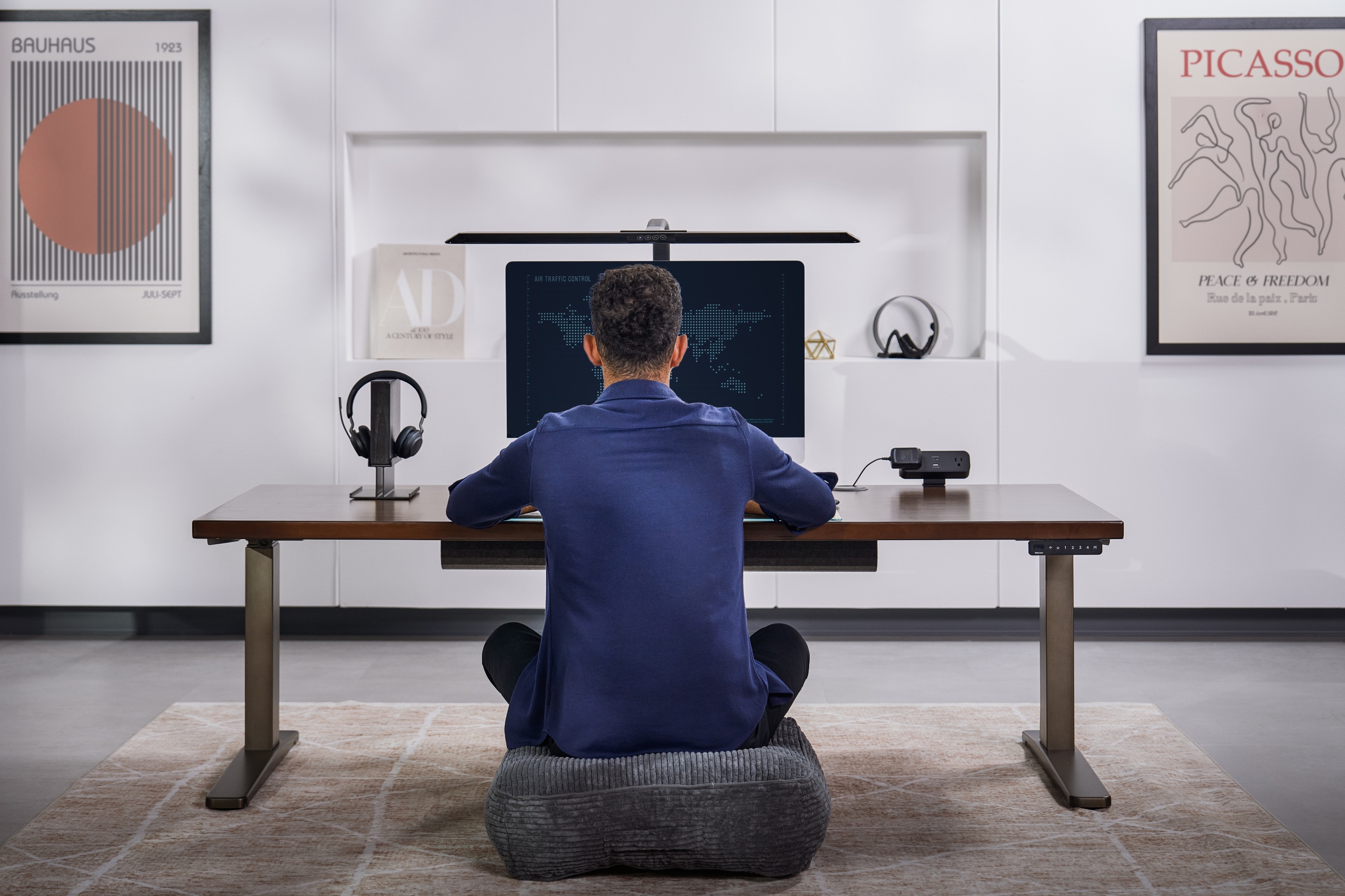 V2 2-leg standing desk with industrial style frame being used at lowest height