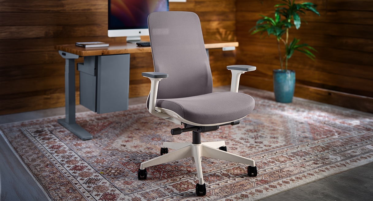 Bolan Ergonomic Chair paired with UPLIFT standing desk in contemporary office workspace setting