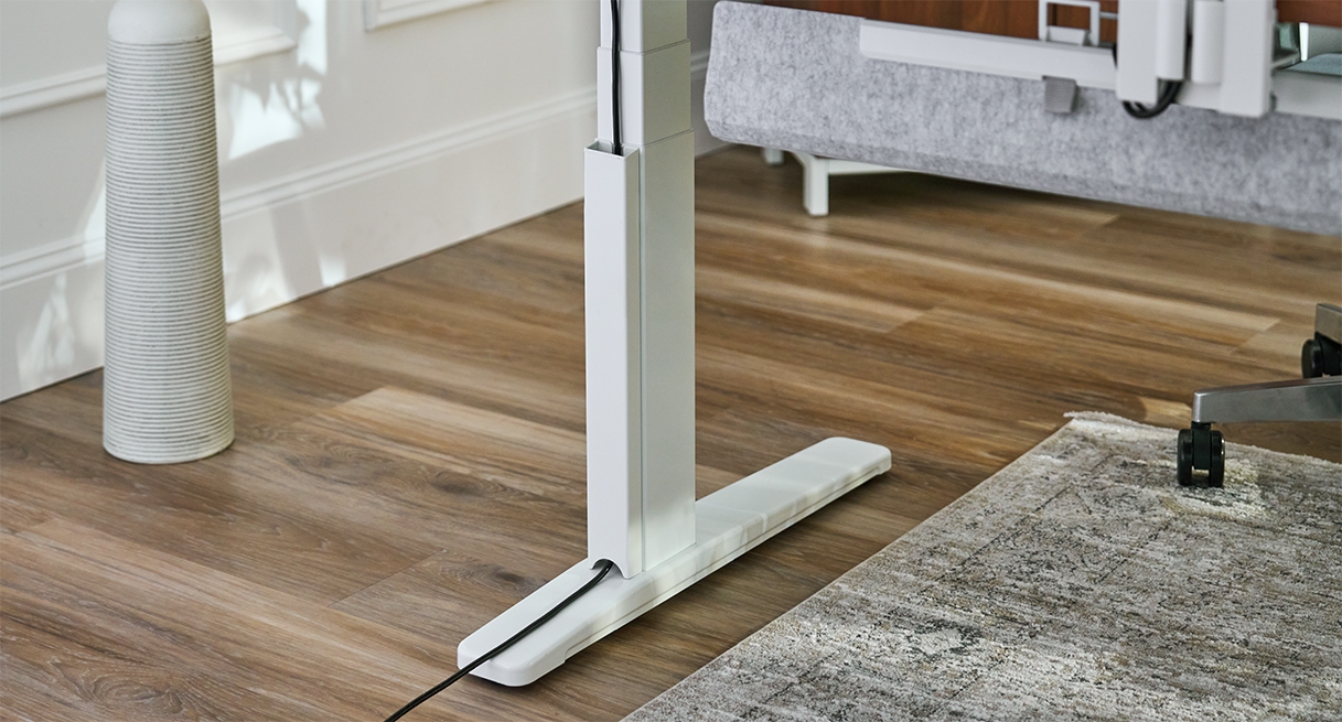 White UPLIFT Desk frame leg with matching Magnetic Cable Channel creating a tidy, seamless aesthetic.