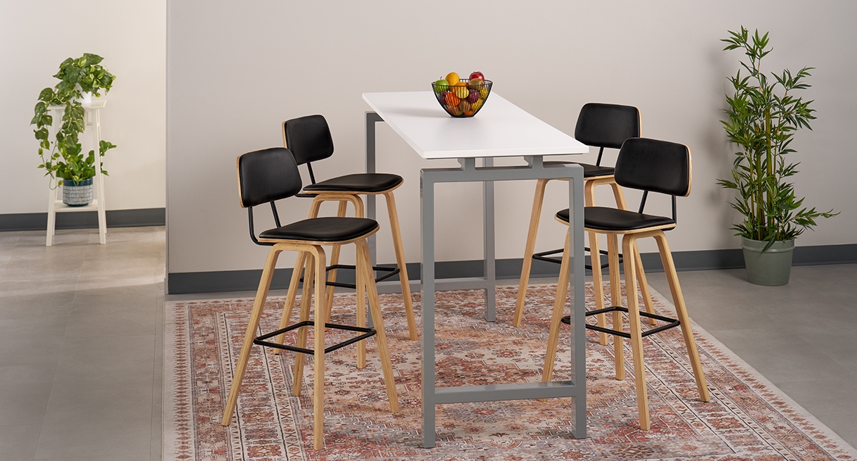 Four Kerbey Barstools by UPLIFT Desk positioned around a bar-height table