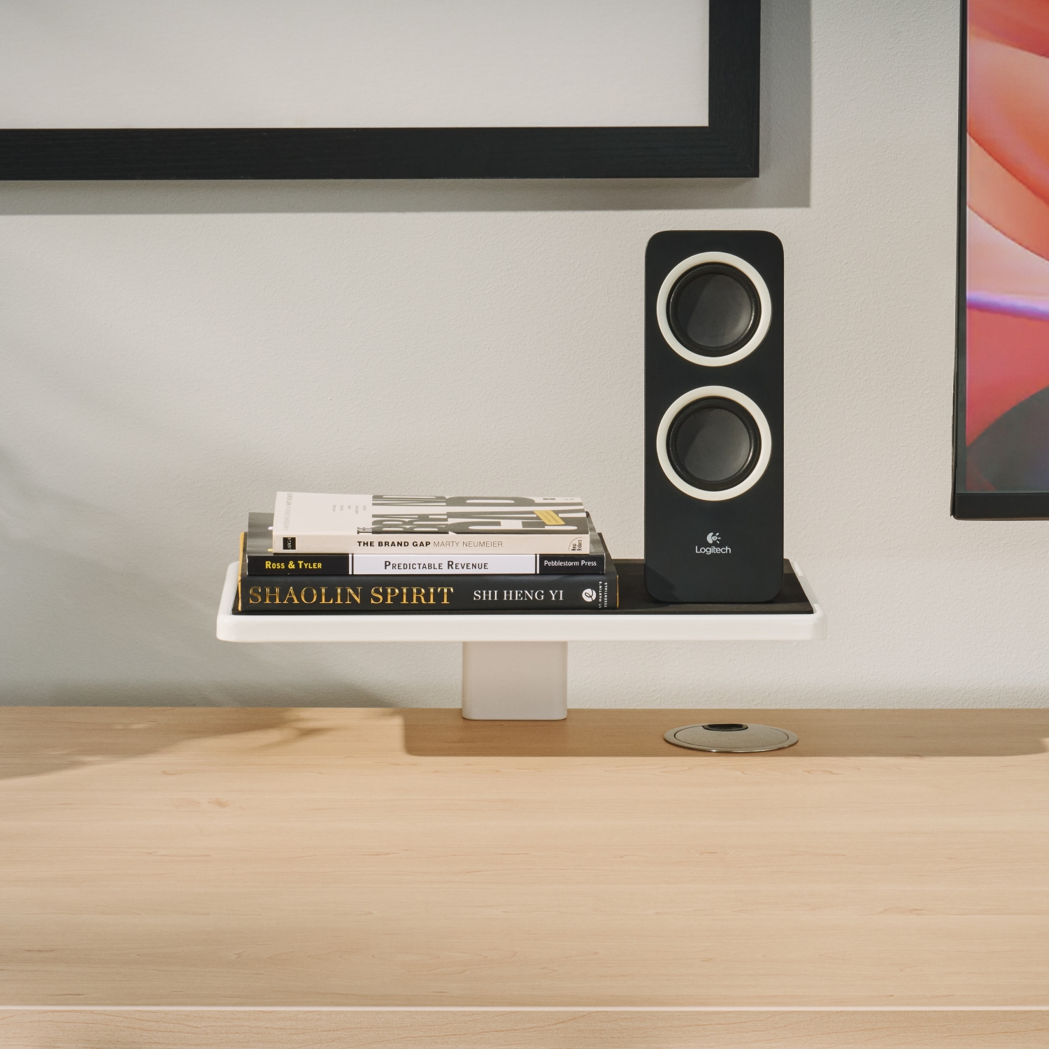 Shelving on desktop supporting desktop speakers