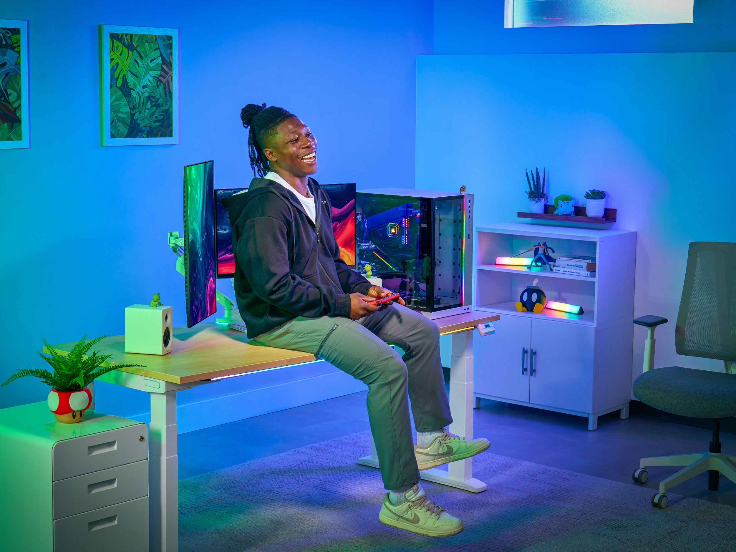 V3 4-Leg Standing Desk with Laminate White Frame and person sitting on it
