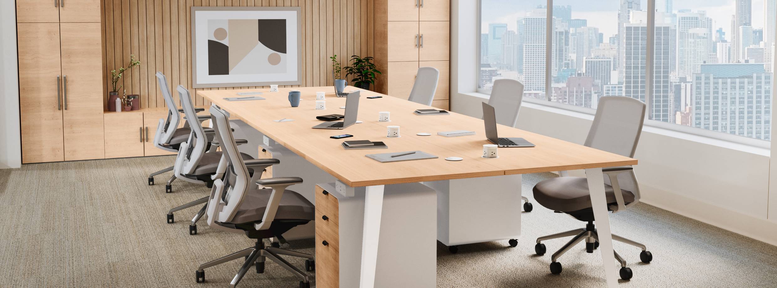 6-Person Table by UPLIFT Desk in Maple in a large conference room with Envoke Ergonomic Chairs and MoPac cabinets