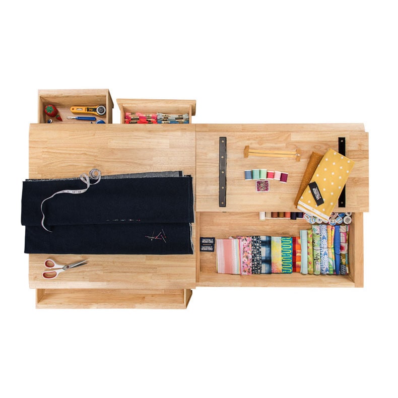 UPLIFT Craft Table's drawers and compartments exposed to show stored craft supplies