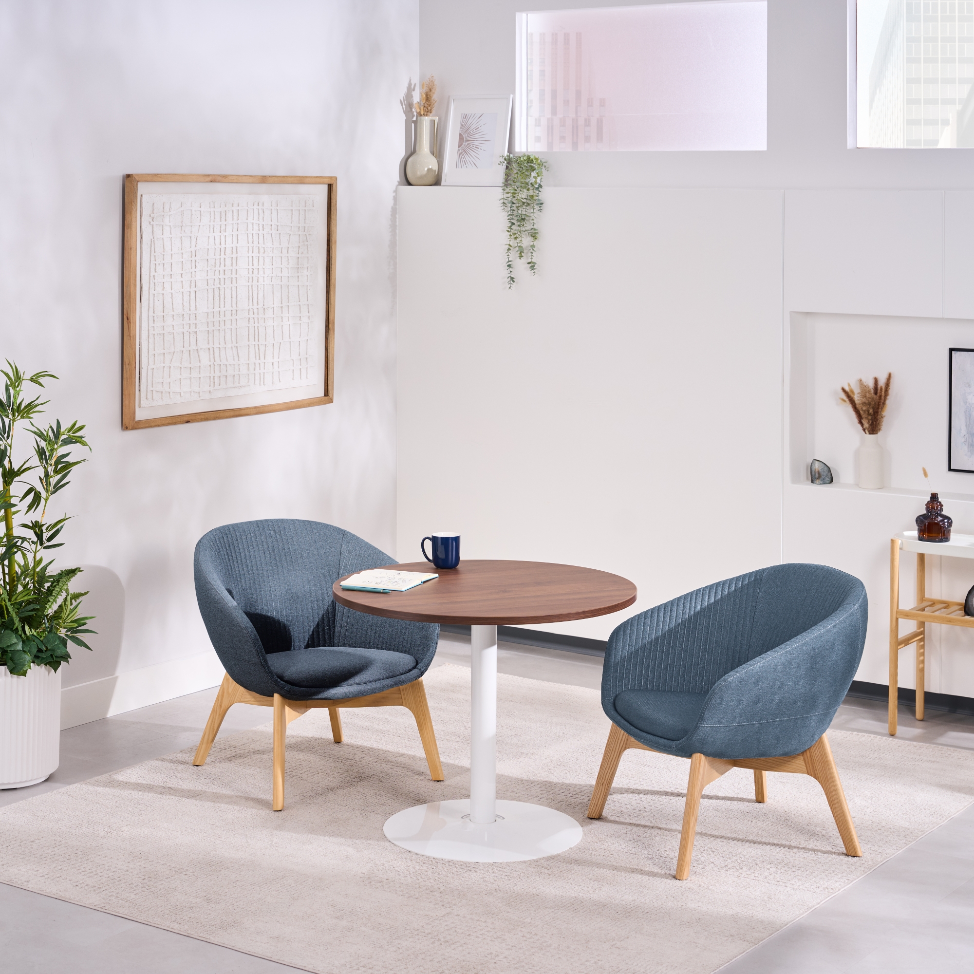 Two Rivervue Lounge Chairs in Basalt Blue at a Cafe Table by UPLIFT Desk