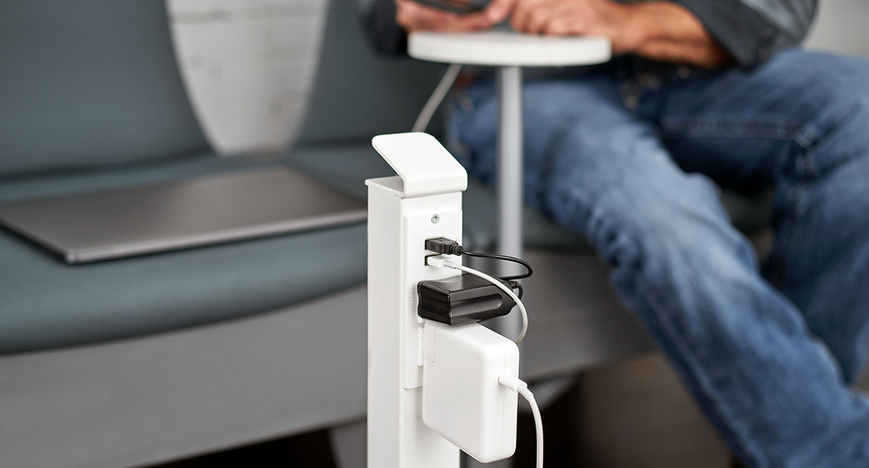 Chargers plugged into a Power Tower by UPLIFT Desk