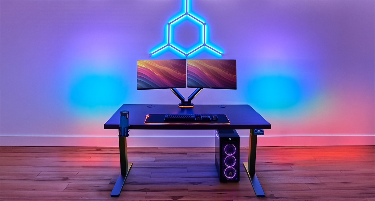 UPLIFT height adjustable gaming desk setup with dual monitors and gaming computer.