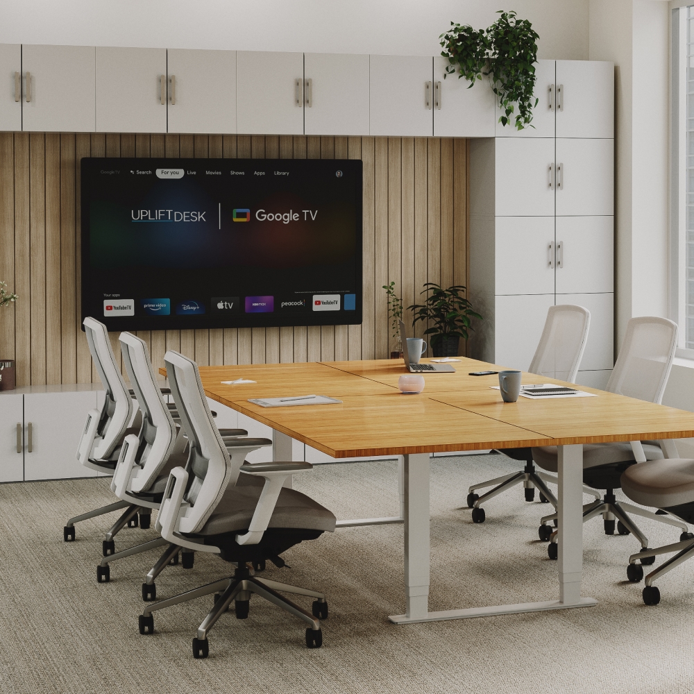 Ergonomic office layout with an UPLIFT Desk height adjustable conference table.