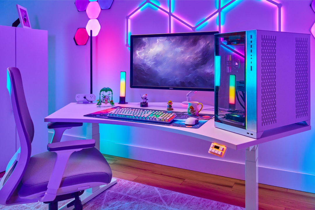 UPLIFT 120-Degree Standing Desk with a cutesy gaming setup and RGB lighting.