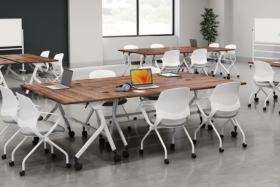Flip top tables with rollaway chairs by UPLIFT Desk in an education setting.