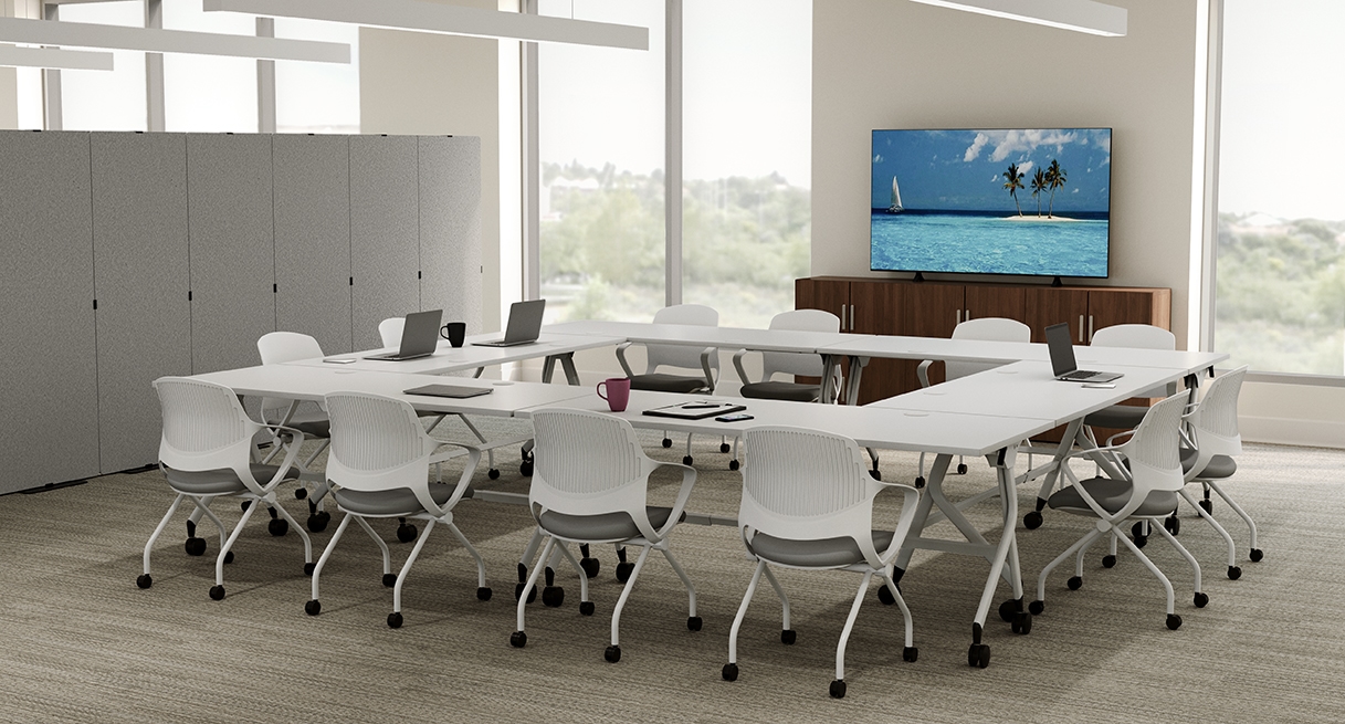 A U-shape configuration with 60" x 30" white laminate Flip Top Tables and Rollaway Nesting Chairs create a collaborative workspace.