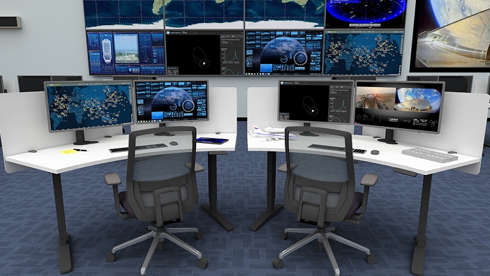 Two height-adjustable desks with multiple monitors and two Envoke Ergonomic Chairs by UPLIFT Desk in a modern mission control workspace setup.