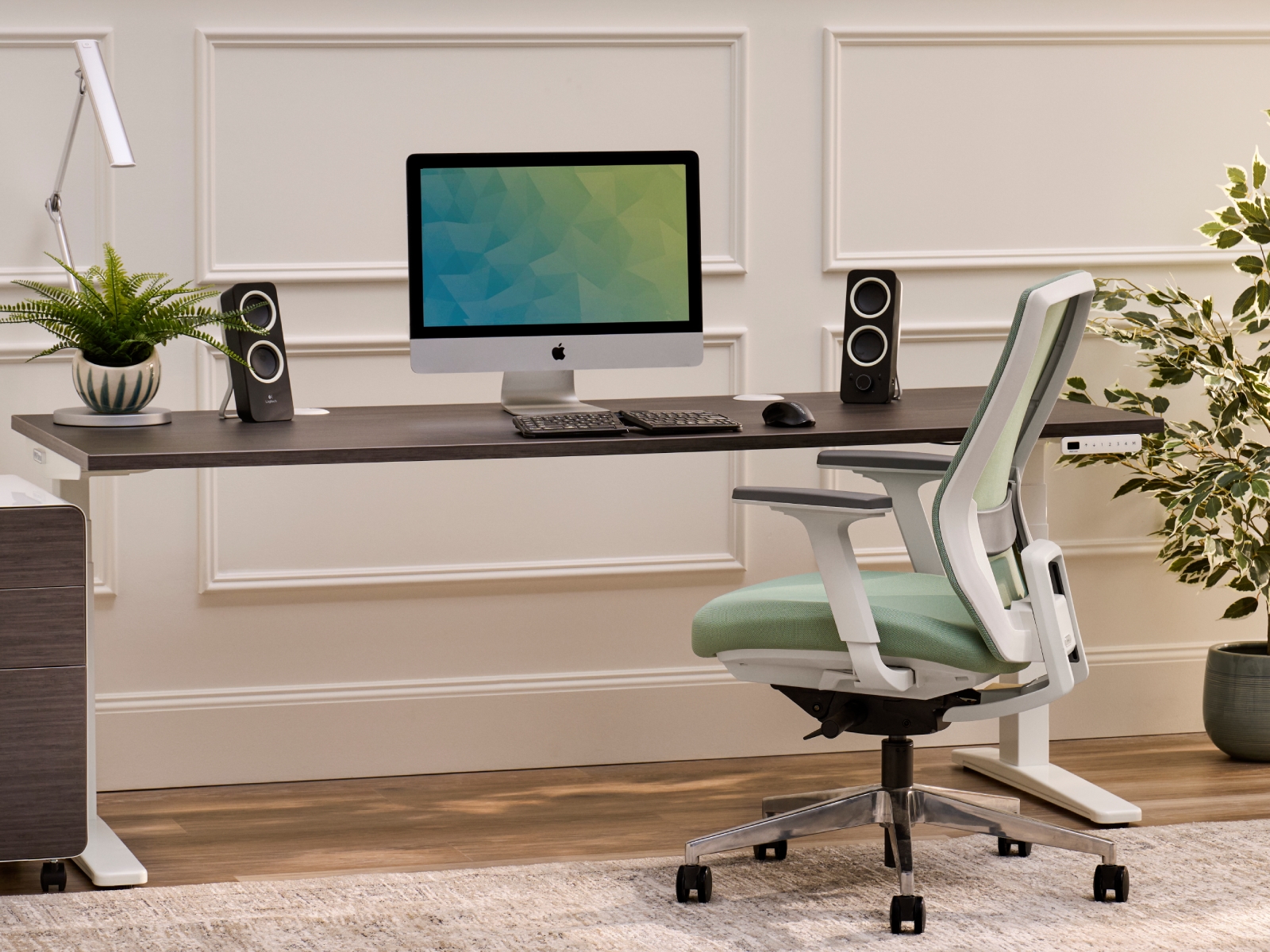 Sage Envoke ergonomic chair with an UPLIFT standing desk in ash gray.