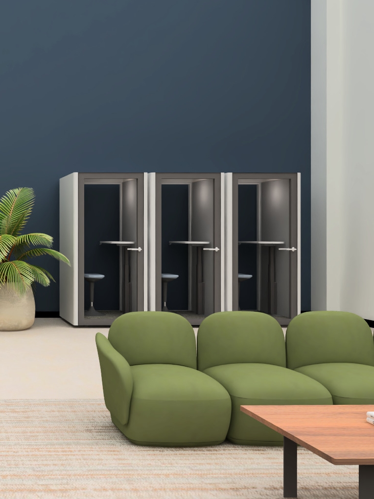 Row of OnePod PhoneBooths behind a set of green dillo lounge chairs in an office designed by UPLIFT Desk