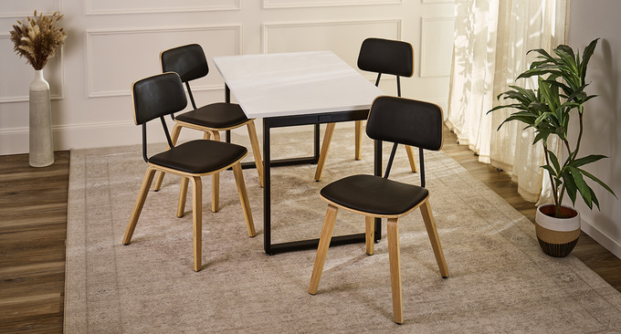 Four Kerbey chairs positioned around a fixed-height table by UPLIFT Desk