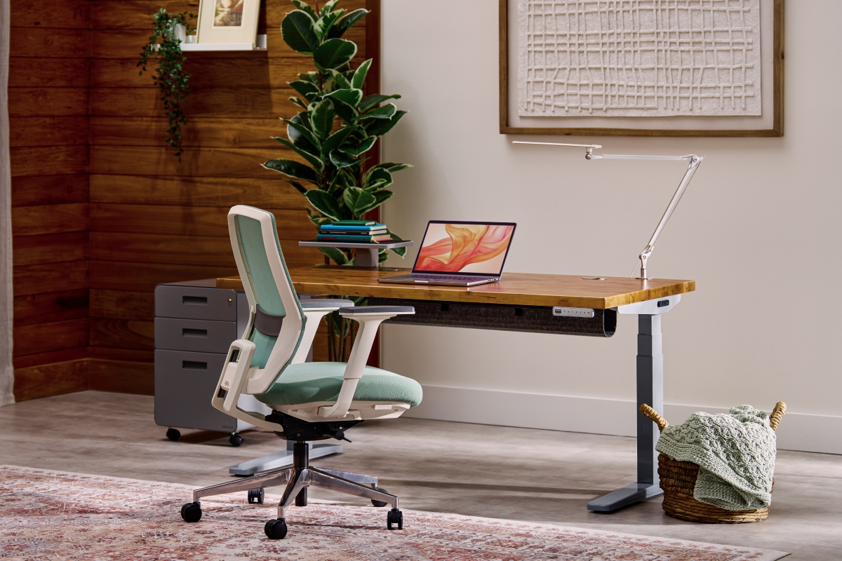 UPLIFT standing desk with a chair in a home workspace