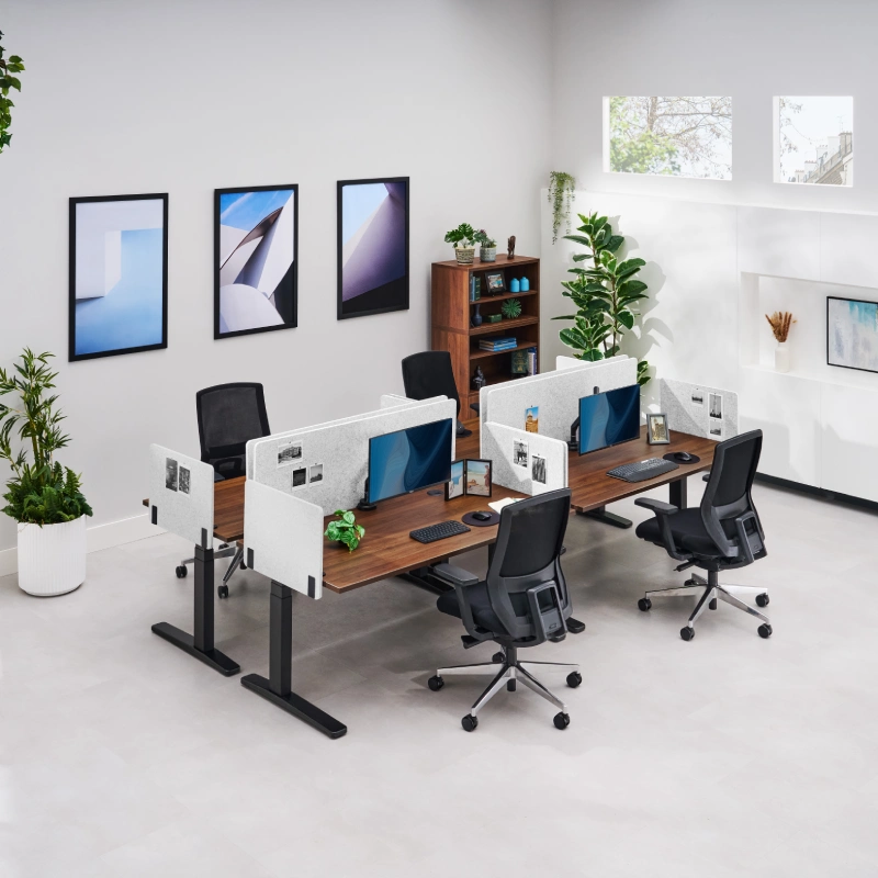 Light gray desk mounted Acoustic Privacy Panels by UPLIFT Desk on a double sided row of standing desks