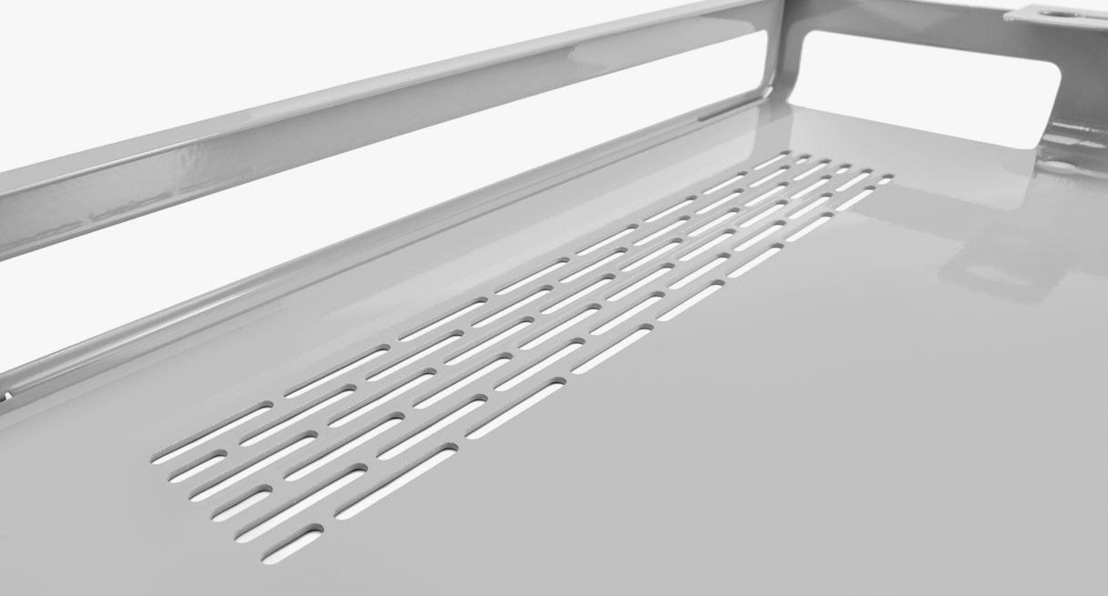 A view of the inside of the shelf, showing perforated cooling and cable routing holes