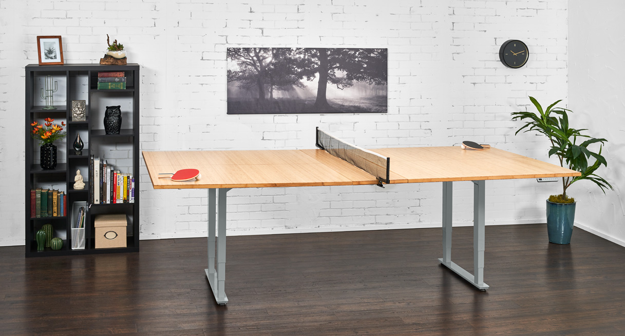 The ping-pong conference table in an office with the ping-pong net set up and ready for play