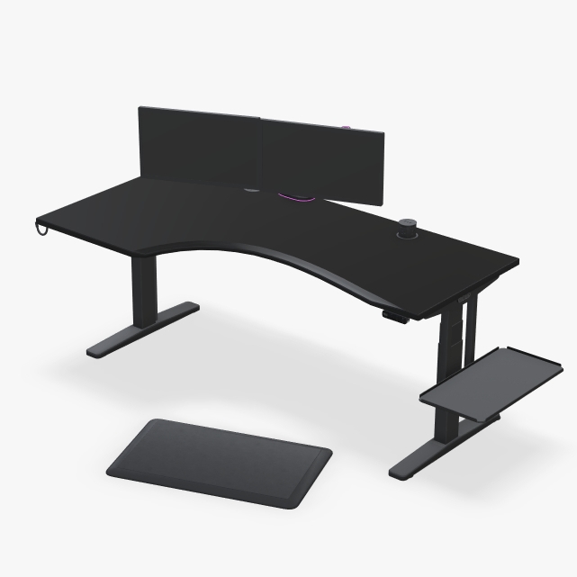 UPLIFT curved corner standing desk with a black laminate desktop and dark gaming accessories.