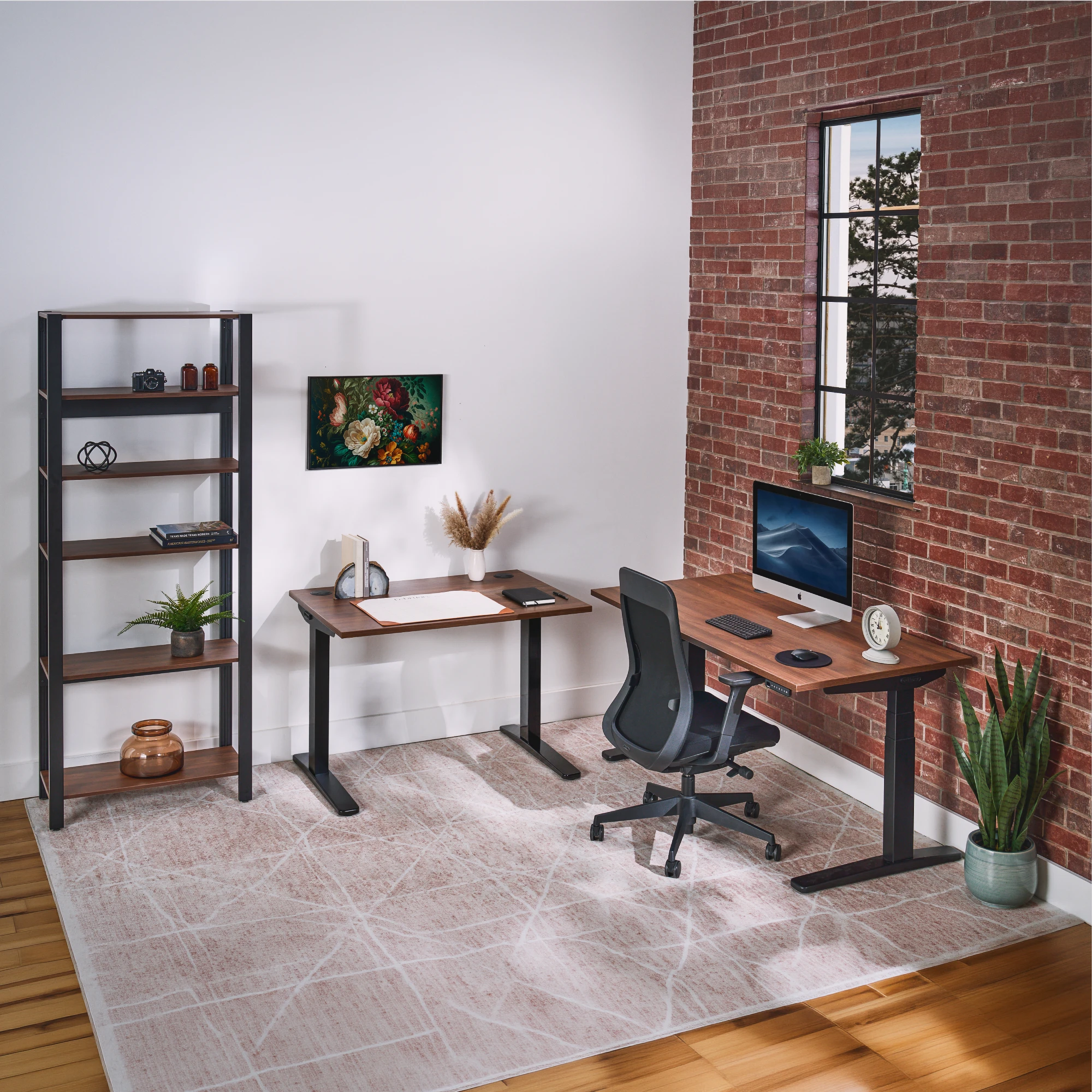Walnut laminate UPLIFT Standing Desk and matching Seated Height 2-Leg Table in an industrial-style home office