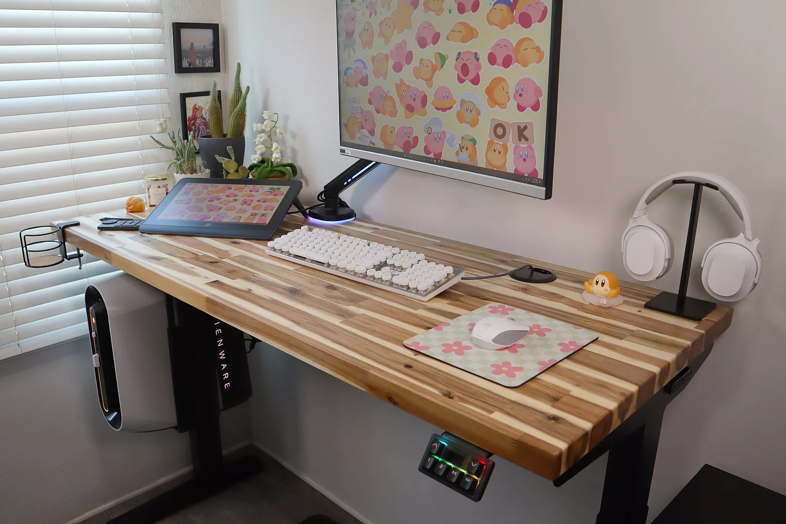 Alt: Uplift Standing Desk with Acacia butcher block desktop in a cozy home office setting.