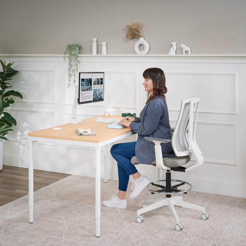 Person sitting in a Clarksville Drafting Chair in Fog at a Persons Standing Desk
