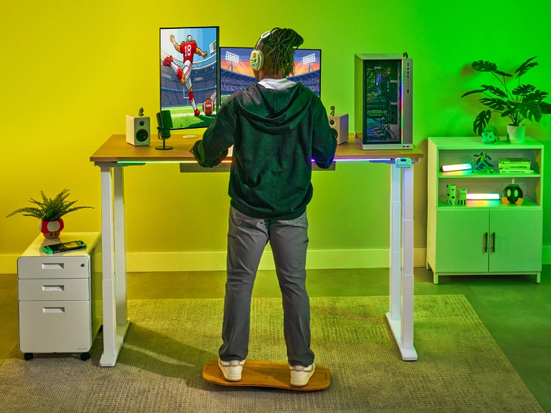 Gaming themed home office featuring the UPLIFT Desk ecosystem including RGB LED Strip for Gaming Keypad