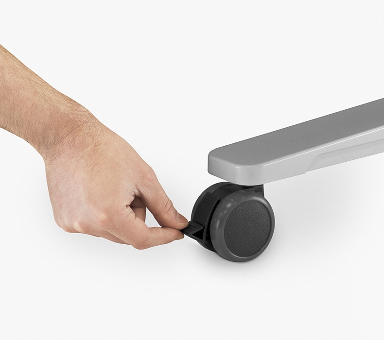 A person locking their Soft Roll Casters in place