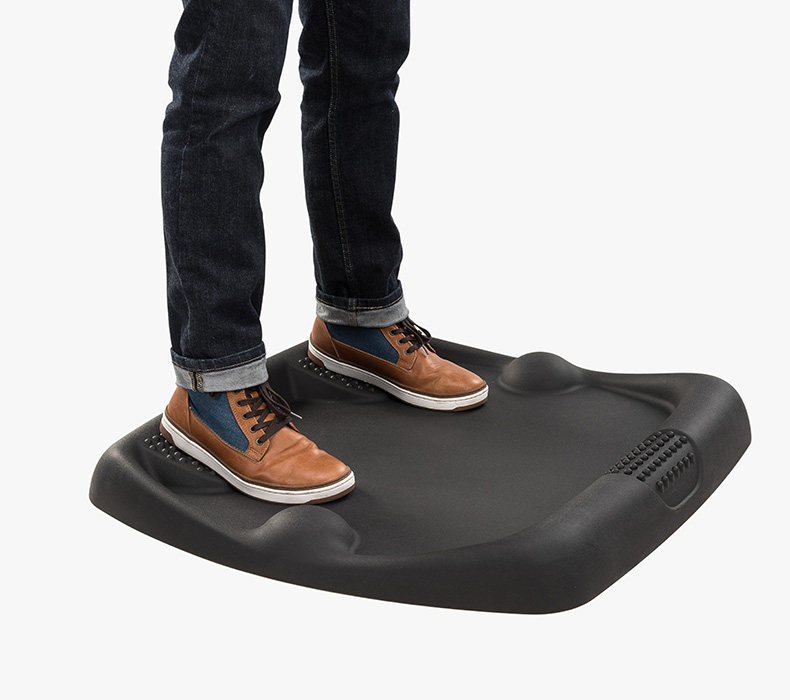 A user stands on the Active Anti-Fatigue Mat E7