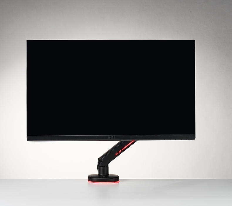 Black Domain RGB single arm set to solid orange light, sitting on a white Eco desktop