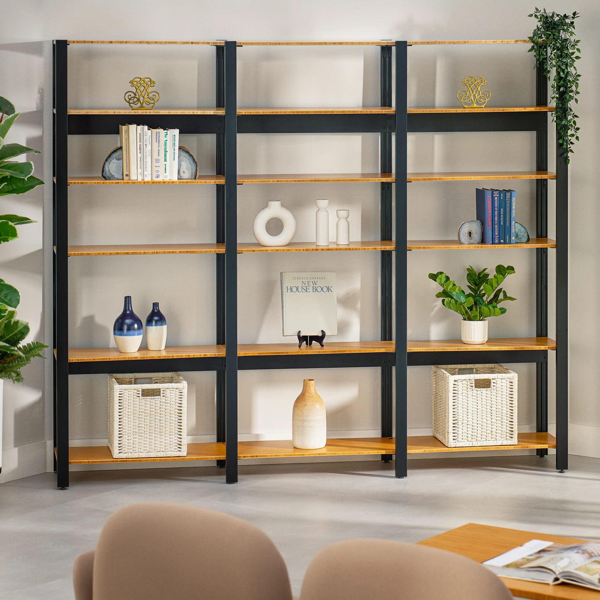Black frame Sequence Shelving with bamboo shelves in a modern office lounge with a cohesive, matching design.