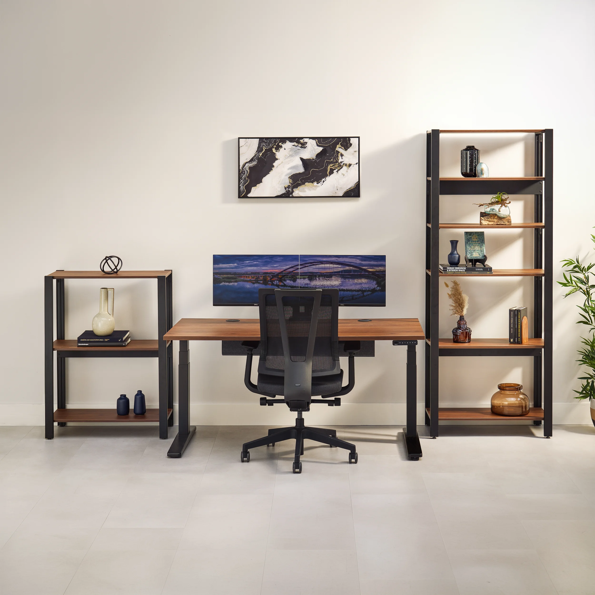 UPLIFT Standing Desk between two modular Sequence Shelving units of different heights in a multi-tier arrangement.