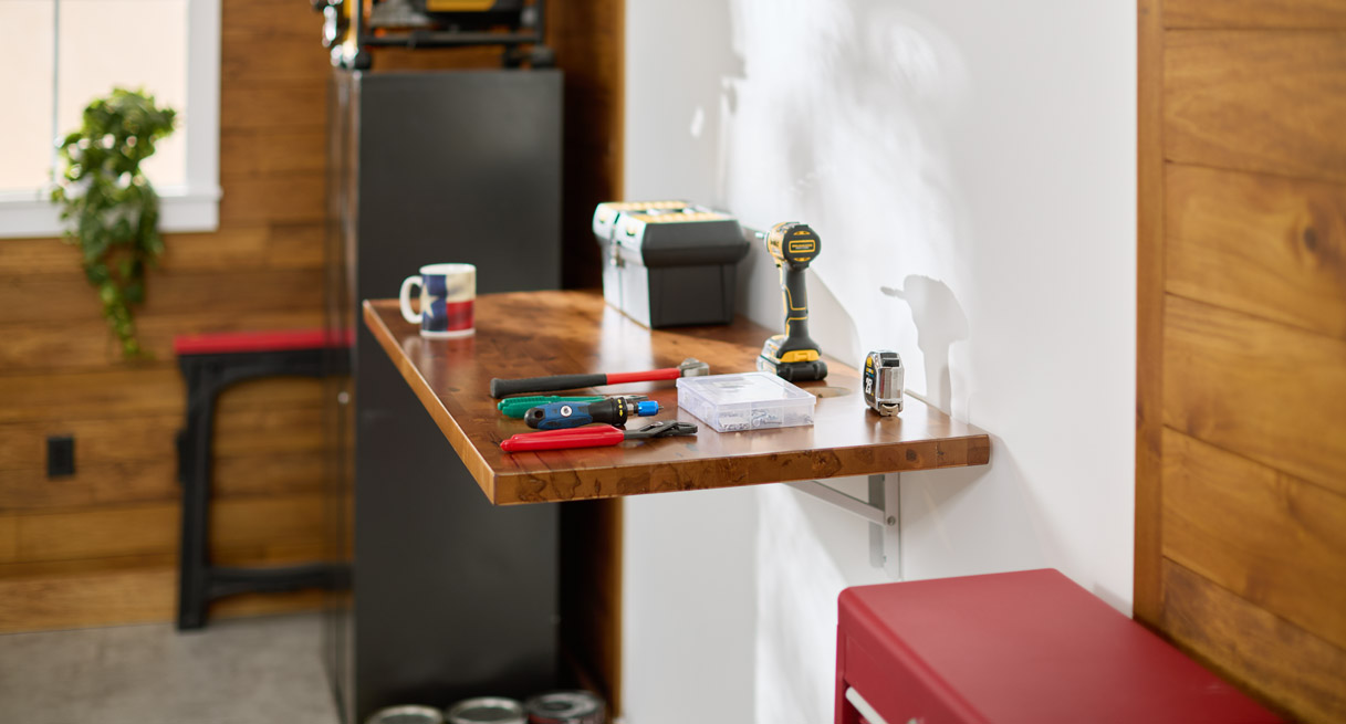 The folding work table being used for tools in a garage