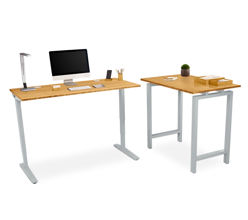 A gray and bamboo standing table desk next to a matching adjustable height desk
