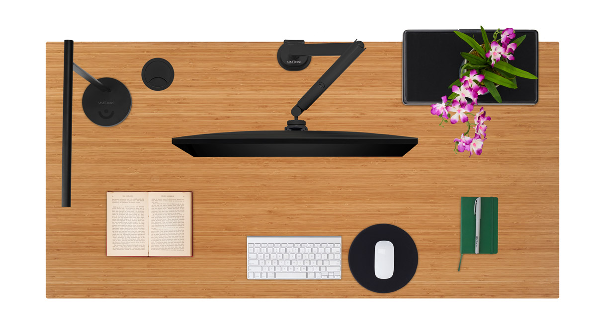 Bamboo desktop with various desk accessories.