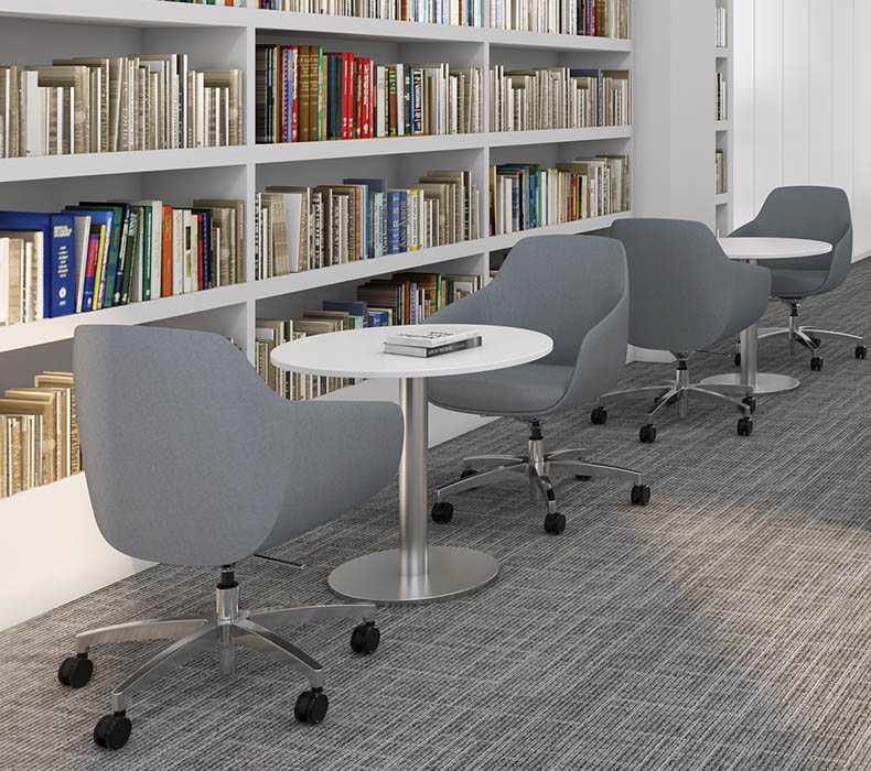 Lilly Side Chairs with wheeled bases around small tables in a library setting